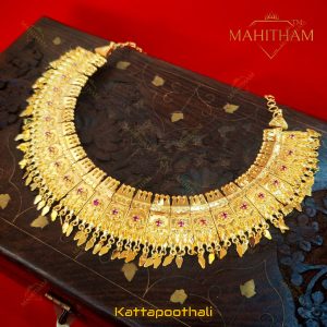Mahitham Kattapoothali traditional necklace displayed in full with gold finish, ruby stone detailing and multiple hanging drops