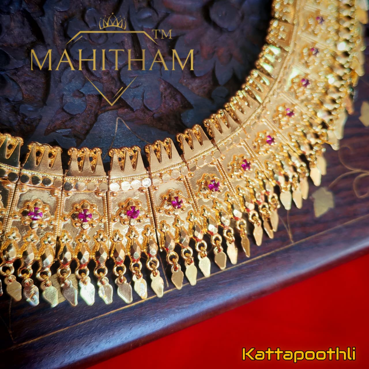 Close-up of Mahitham Kattapoothali Necklace showing detailed gold panels, ruby stone accents and decorative hanging elements