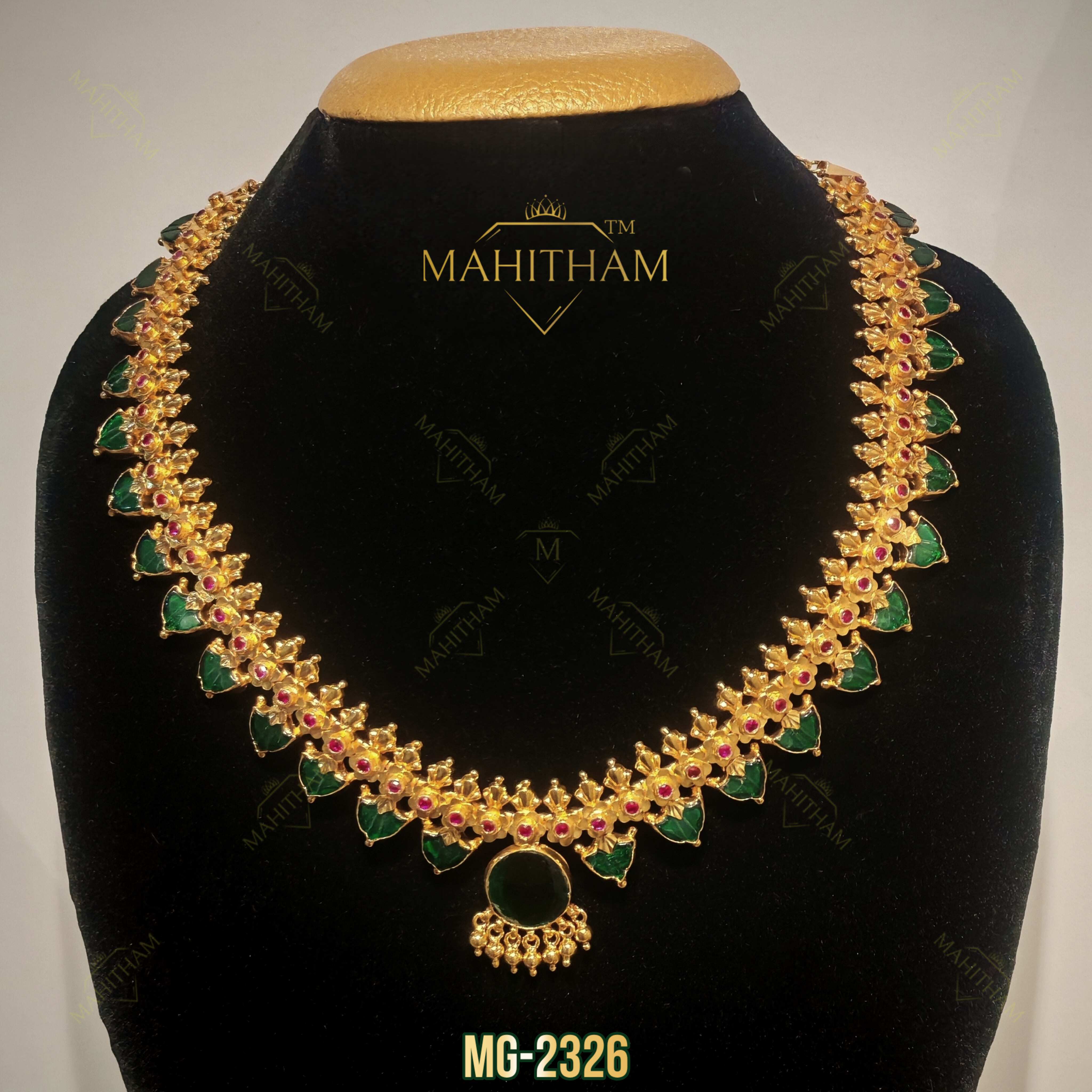 Mahitham Green Palakka Ruby Necklace MG-2326 with green leaf-shaped stones, ruby accents and a round green pendant.